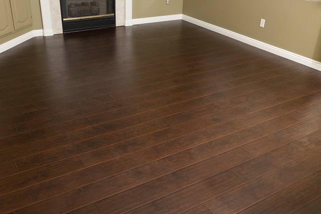 Beautiful Newly Installed Brown Laminate Flooring And Baseboards In 